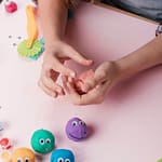 elevated-view-hand-holding-colored-clay-making-craft-art