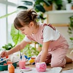 Little girl pot painting at home